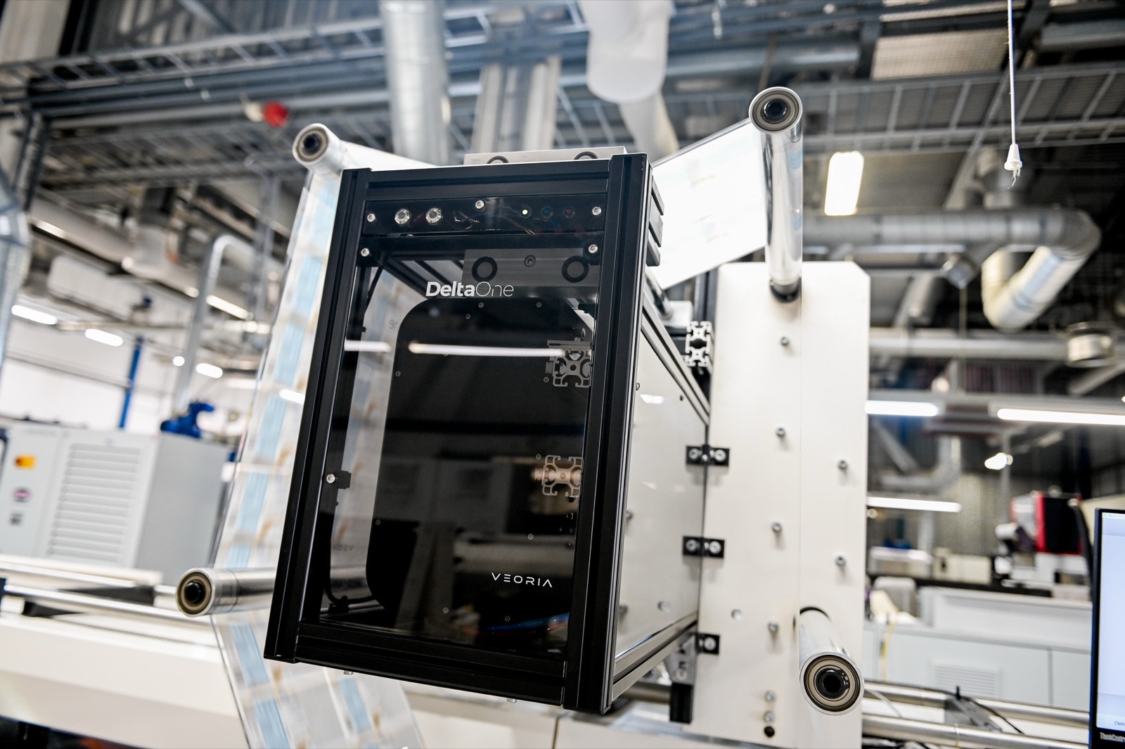 DeltaOne mounted on a flexo press at Eshuis — the printed web entering the scanner